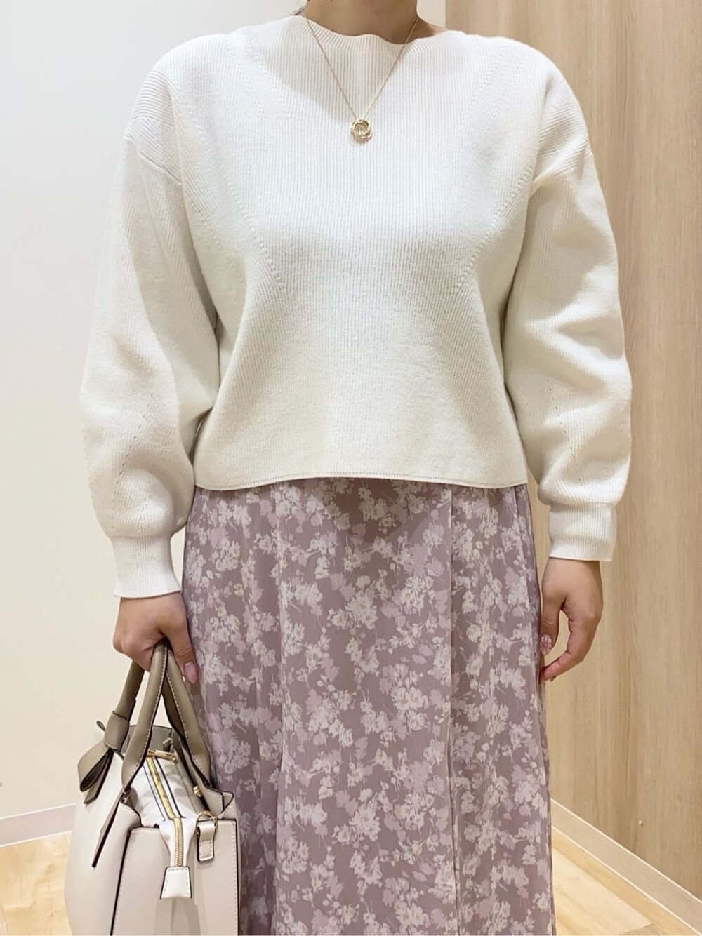 ブラウン系のパンプス、ベージュ系のトートバッグ、ホワイト系のニット/セーターを着用したレディースの冬コーディネートの5枚目の写真