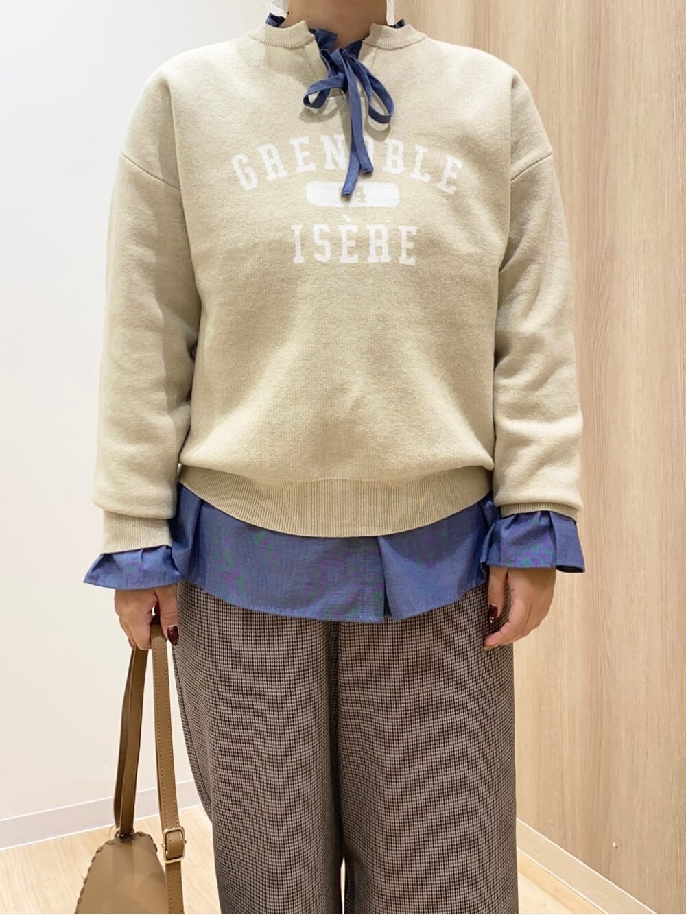 ホワイト系のニット/セーター、ブルー系のシャツ/ブラウス、ベージュ系のその他パンツを着用したレディースの秋コーディネートの5枚目の写真
