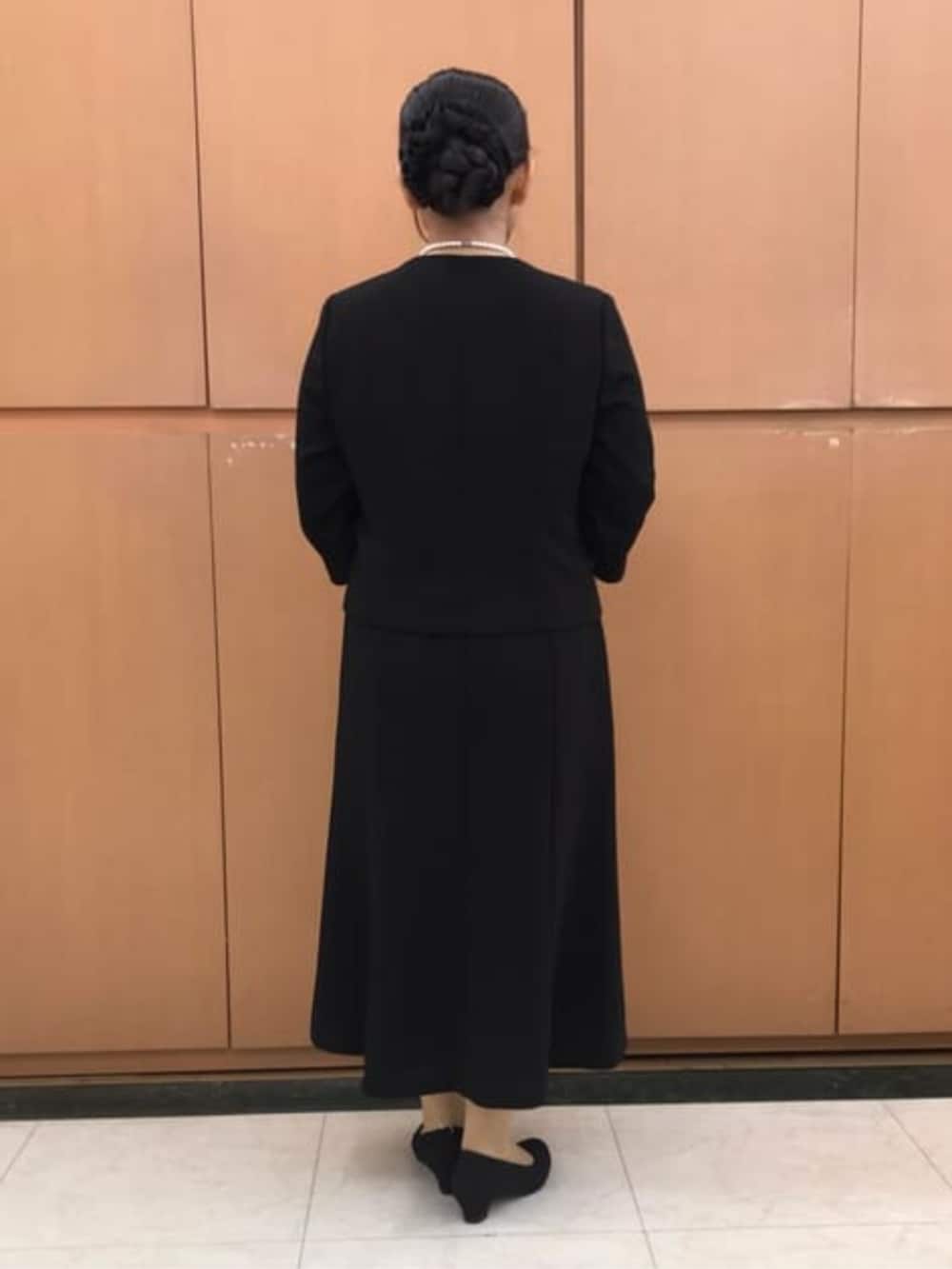 ブラック系のスーツセットを着用したレディースの冬コーディネートの4枚目の写真