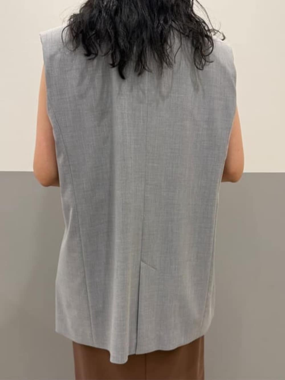 グレー系のベスト、ブラウン系のワンピースを着用したレディースの冬コーディネートの4枚目の写真