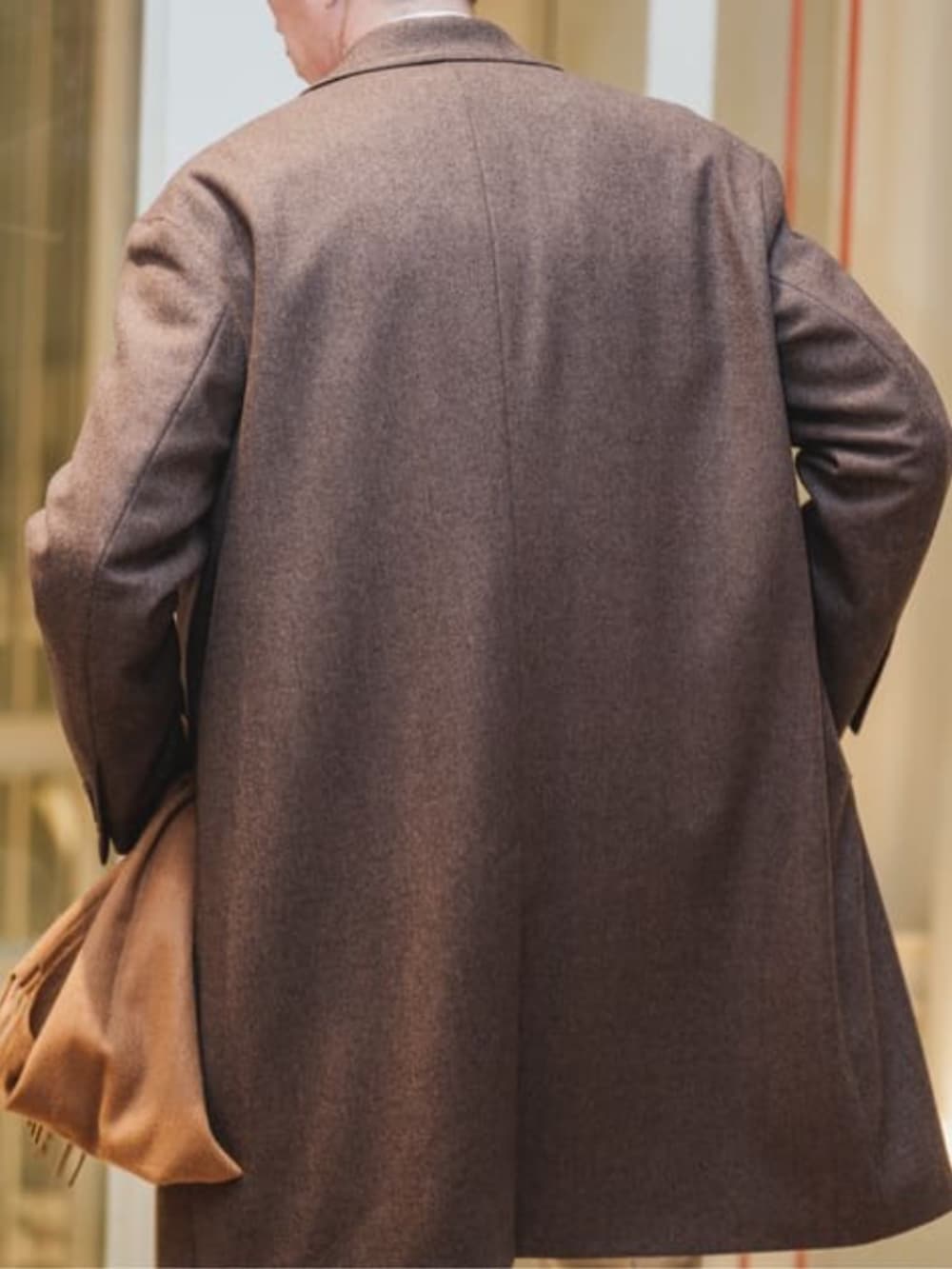 ブラウン系のチェスターコートを着用したメンズの冬コーディネートの5枚目の写真