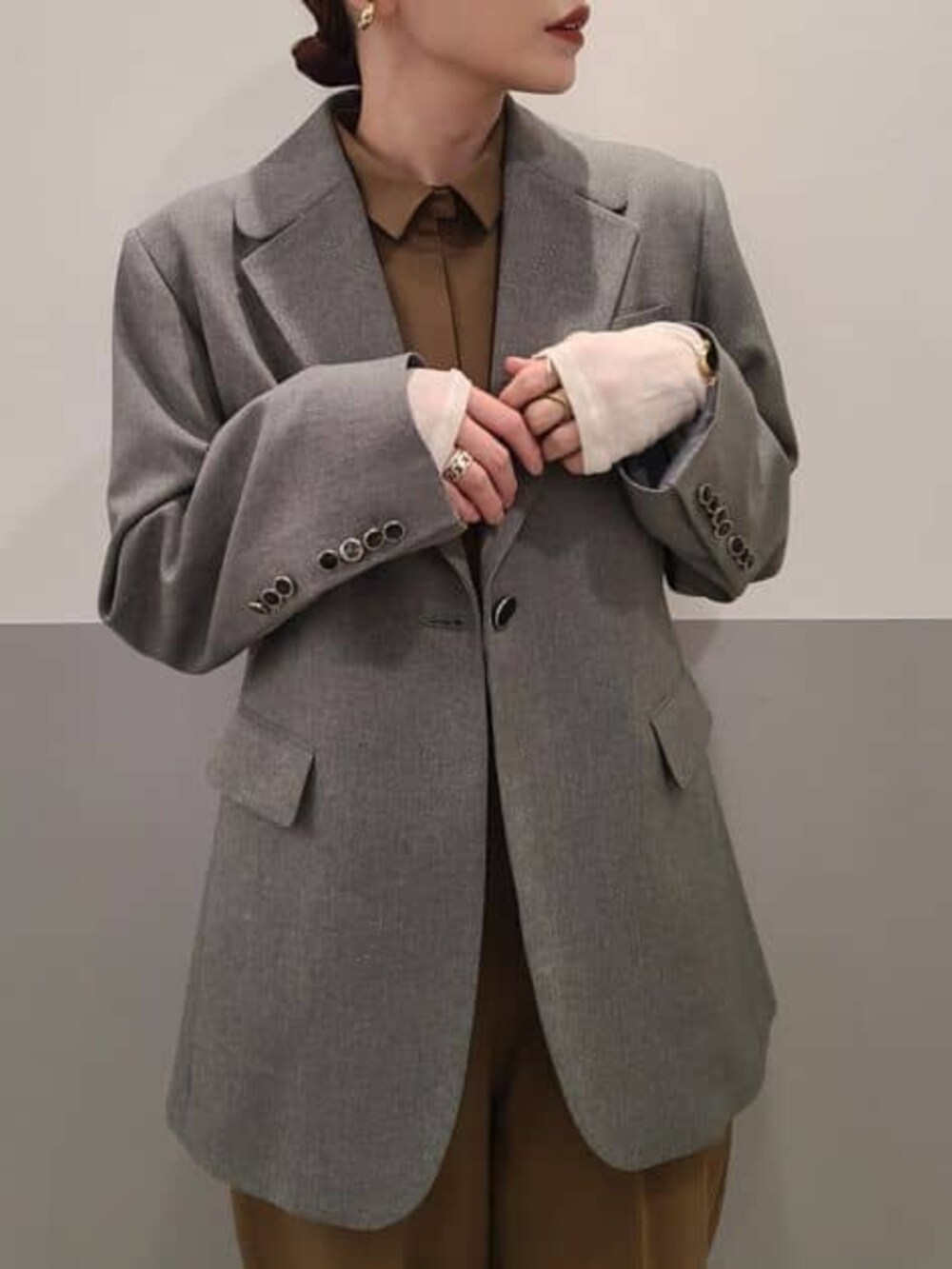 グレー系のテーラードジャケット、ベージュ系のつなぎ/オールインワンを着用したレディースの冬コーディネートの6枚目の写真