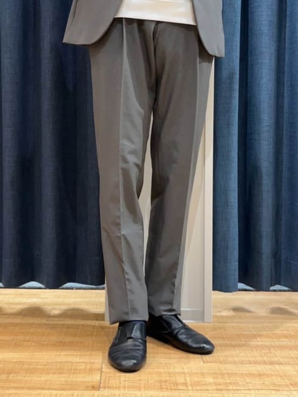 グレー系のスラックス、グレー系のテーラードジャケット、ホワイト系のTシャツ/カットソーを着用したメンズの冬コーディネートの4枚目の写真