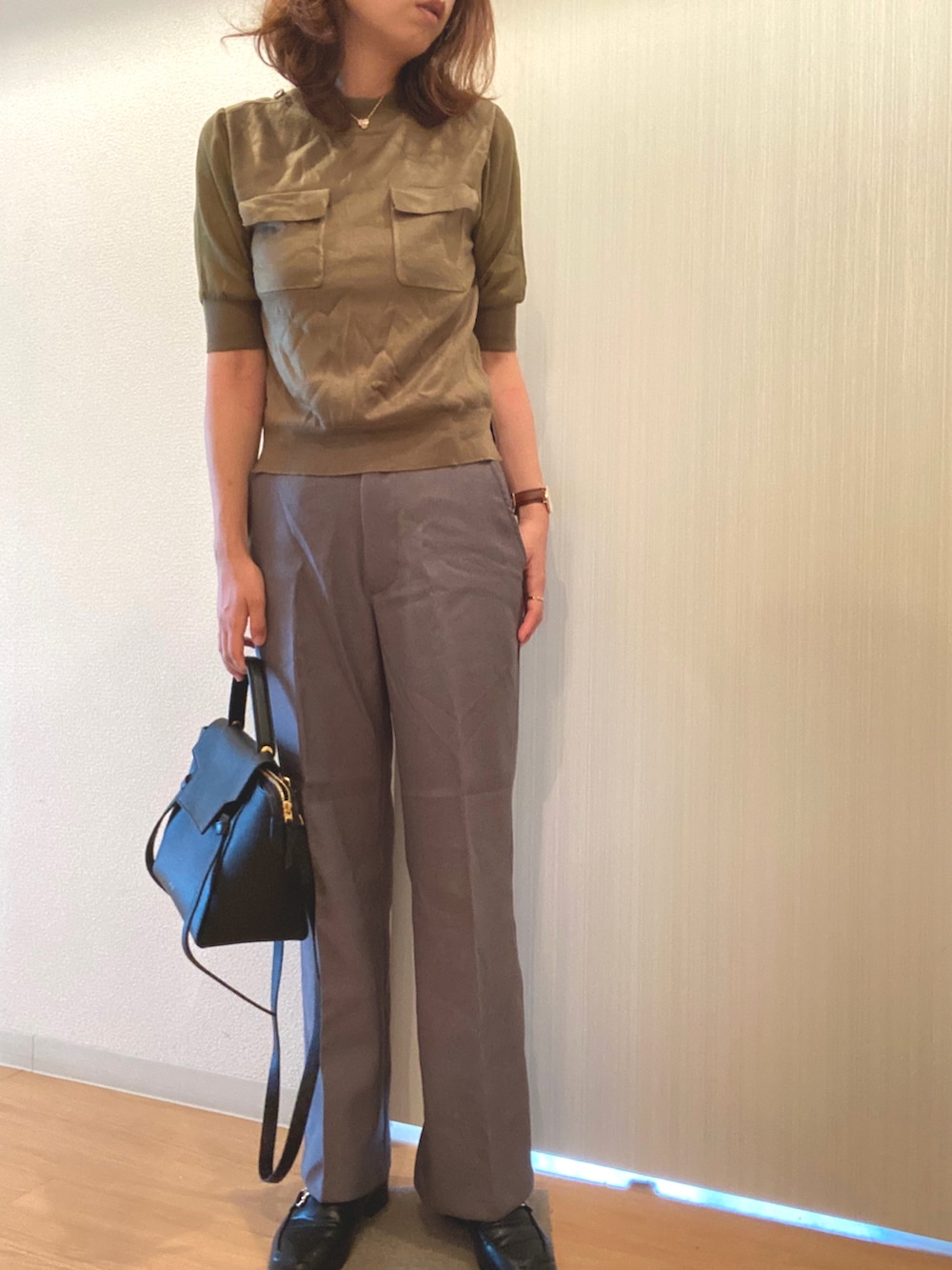 グリーン系のニット/セーター、グレー系のその他パンツ、ブラック系のローファーを着用したレディースの秋コーディネートの2枚目の写真