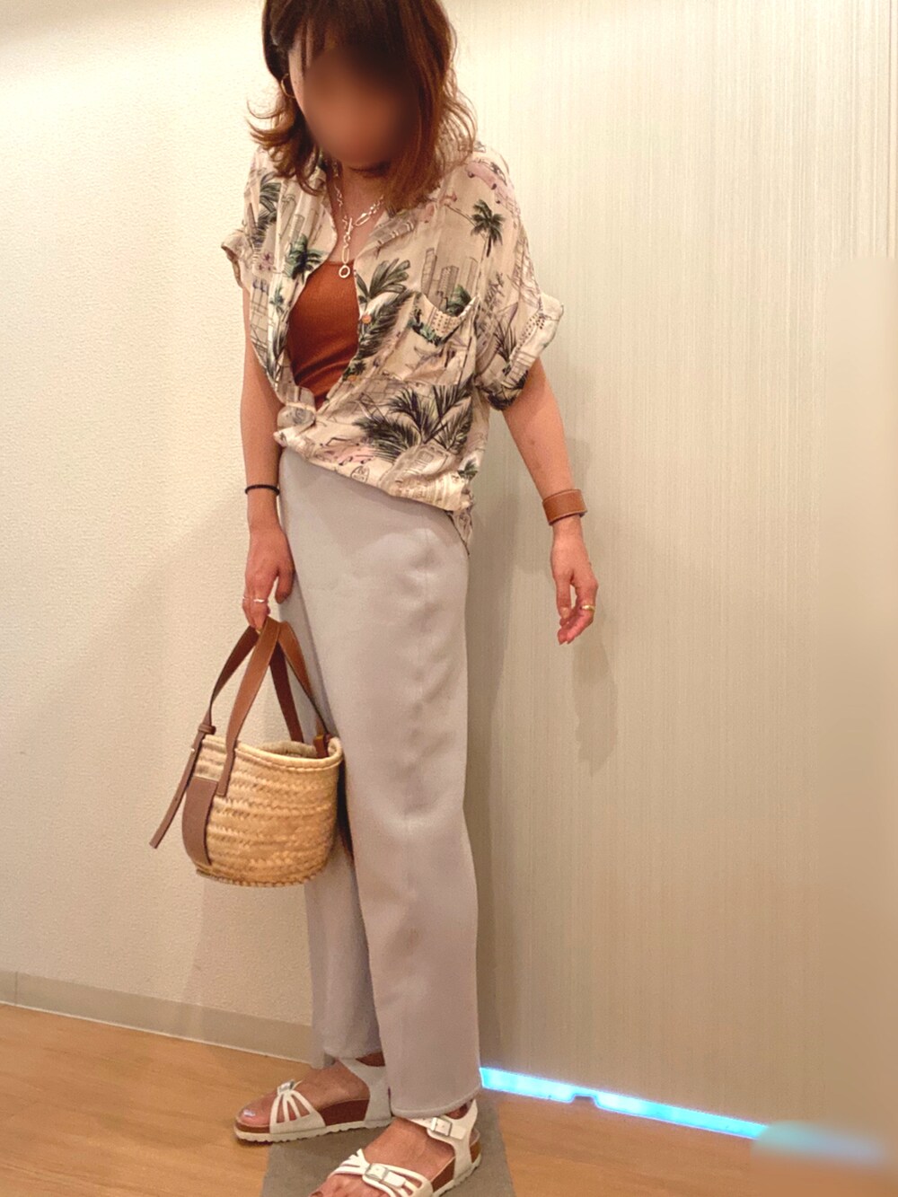 ブラウン系のタンクトップ、ブルー系のスカート、ホワイト系のサンダルを着用したレディースの夏コーディネートの3枚目の写真