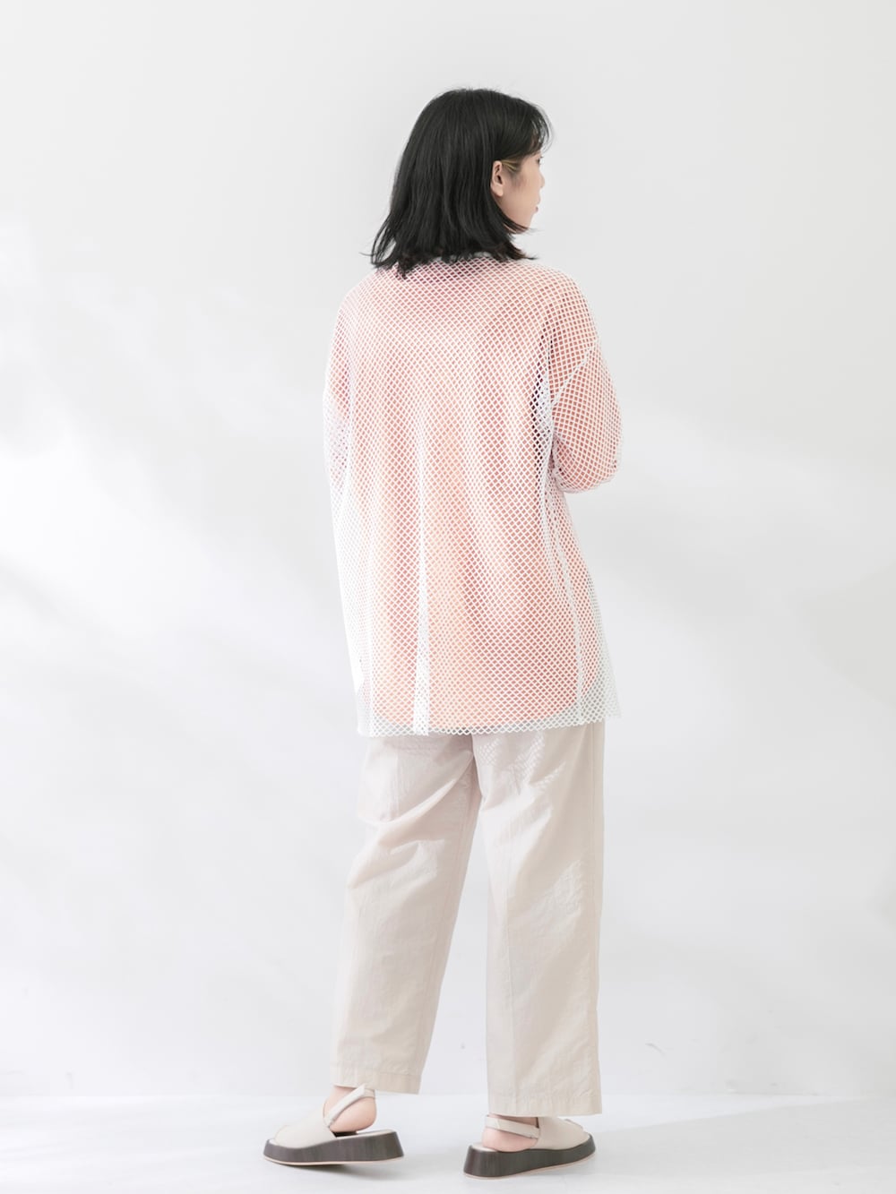 ホワイト系のTシャツ/カットソー、オレンジ系のTシャツ/カットソー、ホワイト系のサンダルを着用したレディースの春コーディネートの2枚目の写真