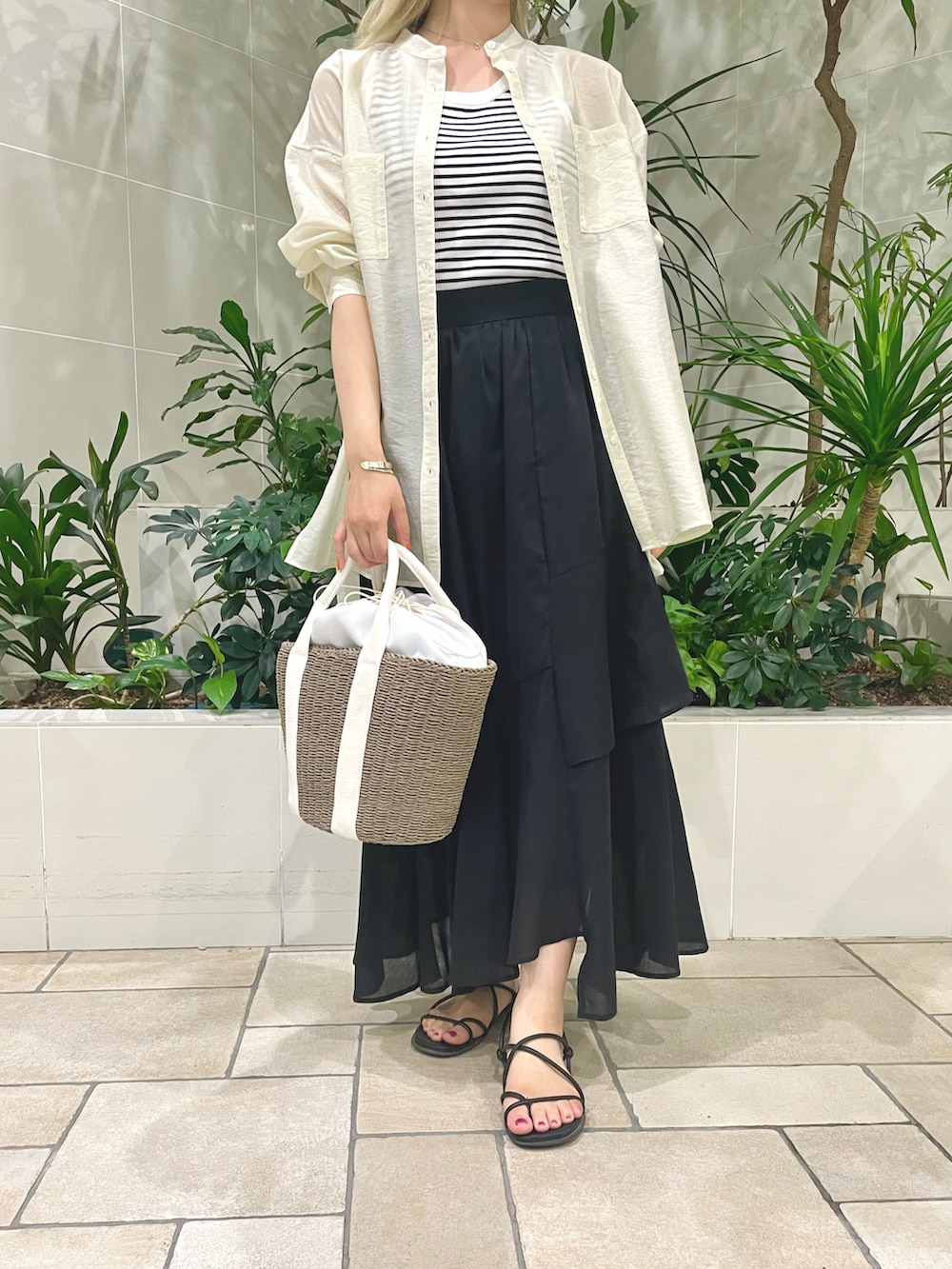 ホワイト系のタンクトップ、ホワイト系のシャツ/ブラウス、ブラック系のスカートを着用したレディースの夏コーディネートの3枚目の写真