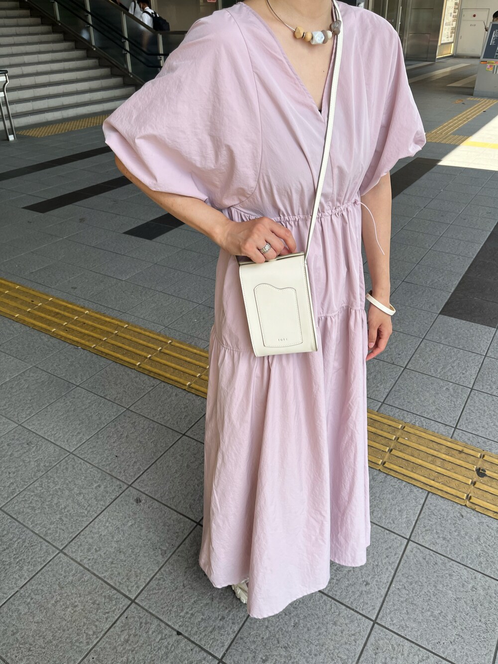 ピンク系のワンピース、ホワイト系のバッグを着用したレディースの夏コーディネートの4枚目の写真