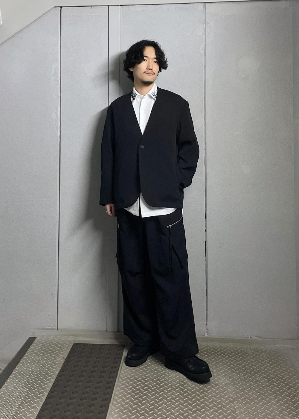 ホワイト系のシャツ/ブラウス、ブラック系のノーカラージャケット、ブラック系のカーゴパンツを着用したメンズの秋コーディネートの2枚目の写真