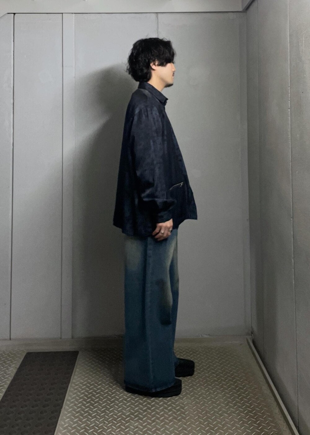 ブルー系のデニムパンツ、グレー系のニット/セーター、ブルー系のシャツ/ブラウスを着用したメンズの冬コーディネートの2枚目の写真