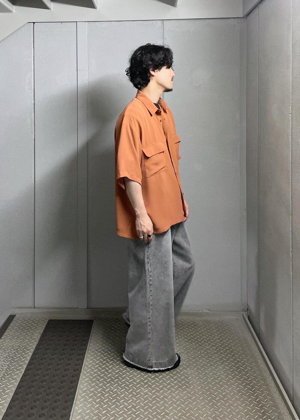 グレー系のデニムパンツ、オレンジ系のシャツ/ブラウスを着用したメンズの夏コーディネートの4枚目の写真