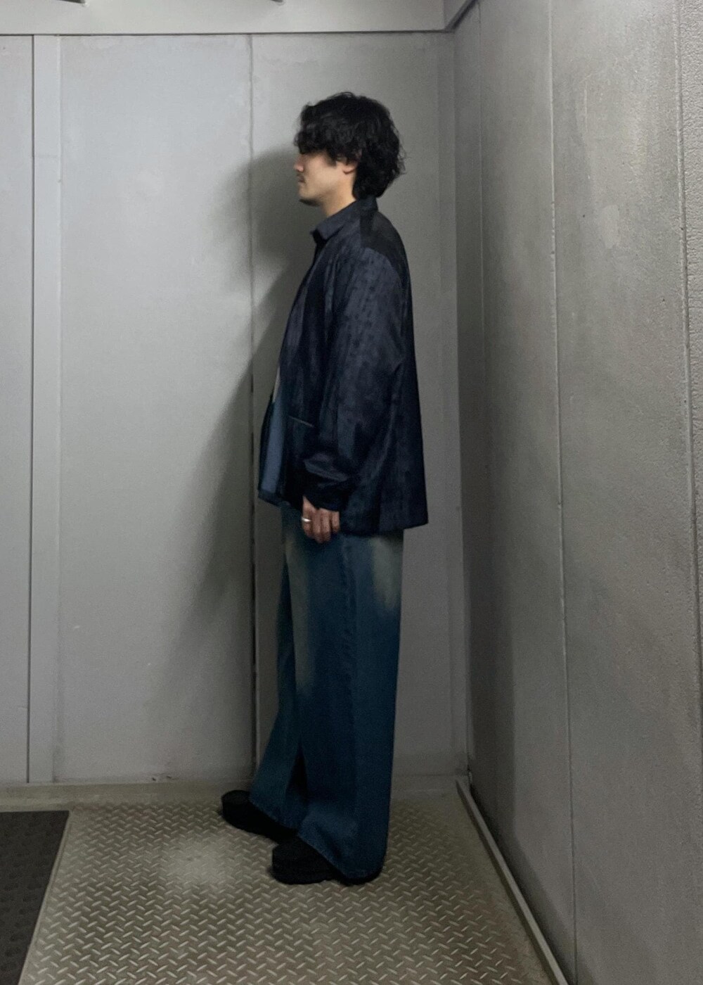 ブルー系のデニムパンツ、グレー系のニット/セーター、ブルー系のシャツ/ブラウスを着用したメンズの冬コーディネートの4枚目の写真