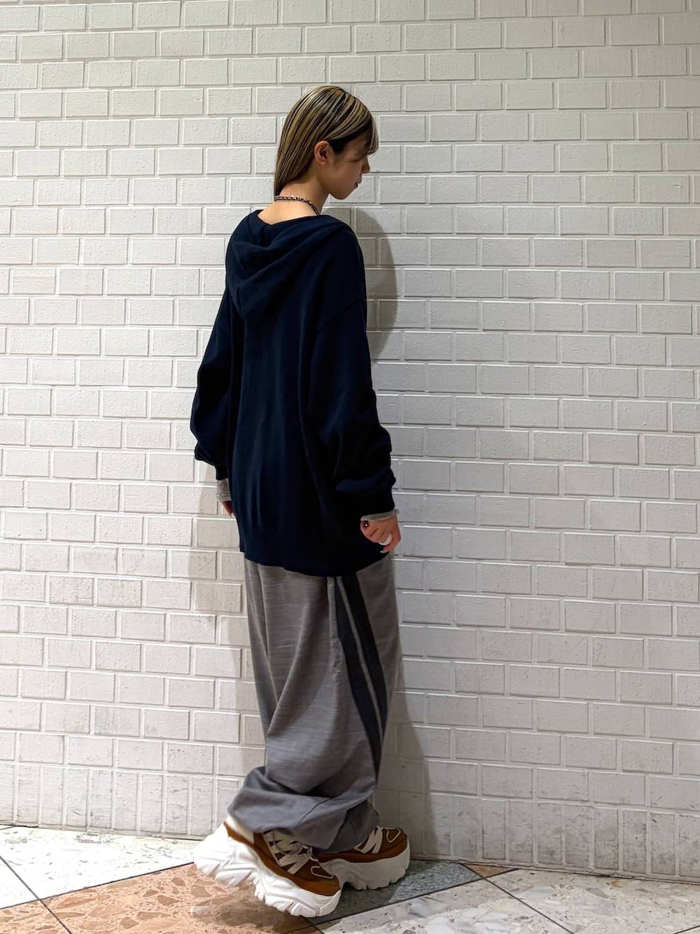 ベージュ系のスニーカー、ブルー系のパーカー、グレー系のその他パンツを着用したレディースの春コーディネートの6枚目の写真