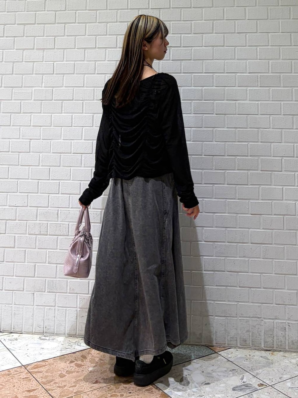 ピンク系のハンドバッグ、ブラック系のワンピース、ブラック系のTシャツ/カットソーを着用したレディースの春コーディネートの6枚目の写真