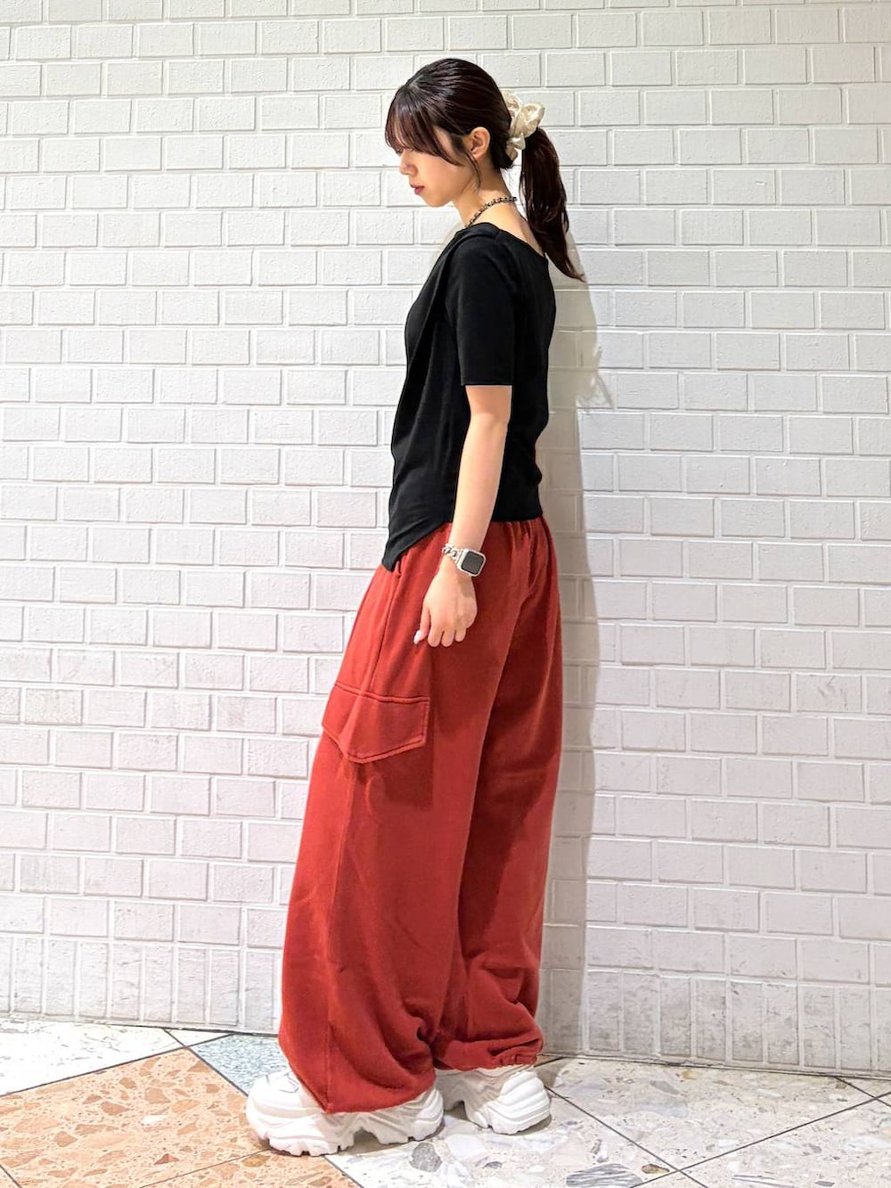 ホワイト系のスニーカー、レッド系のその他パンツ、ブラック系のTシャツ/カットソーを着用したレディースの春コーディネートの6枚目の写真
