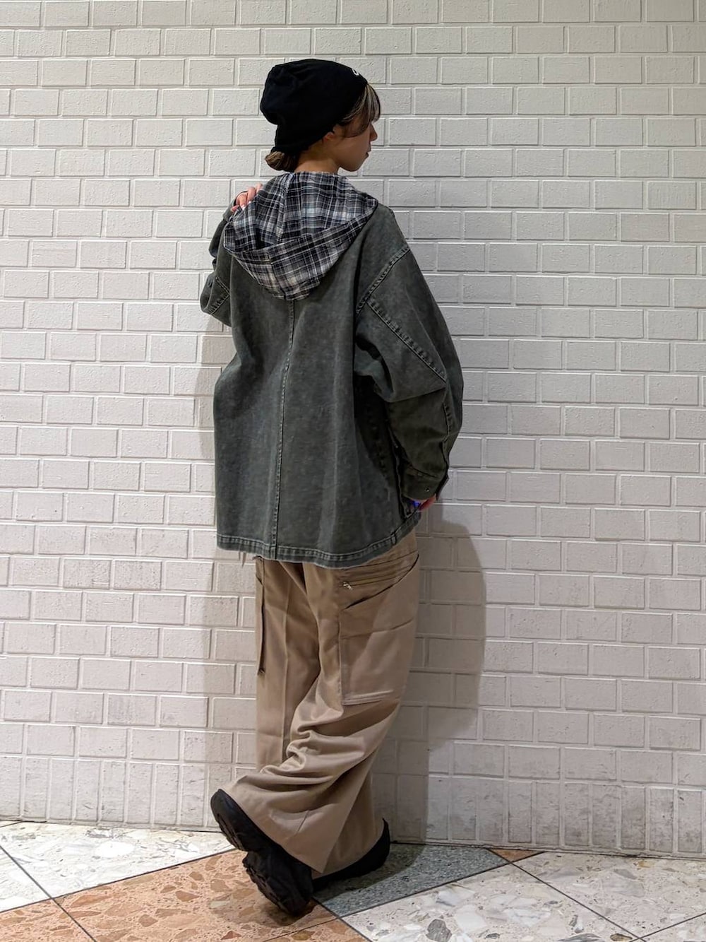 ブラック系のブーツ、ベージュ系のスラックス、ブラック系のシャツ/ブラウスを着用したレディースの春コーディネートの6枚目の写真