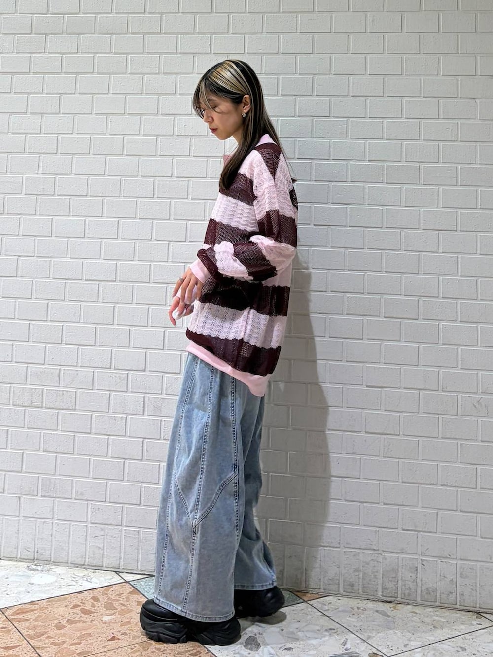 ブルー系のデニムパンツ、ピンク系のポロシャツを着用したレディースの春コーディネートの2枚目の写真