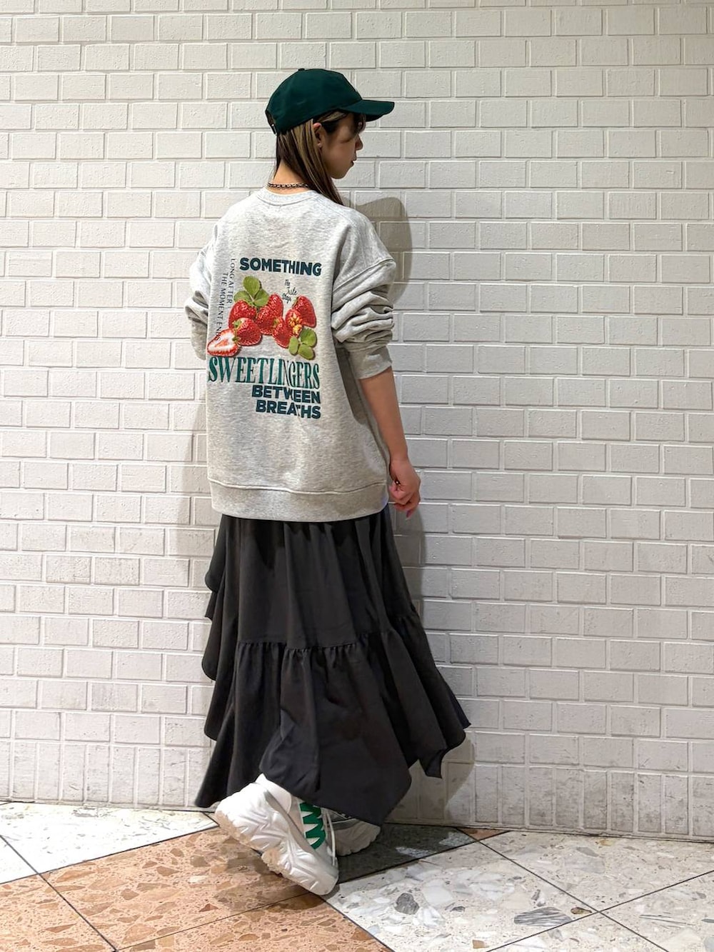 ホワイト系のスニーカー、グレー系のスカート、グレー系のスウェットを着用したレディースの春コーディネートの5枚目の写真