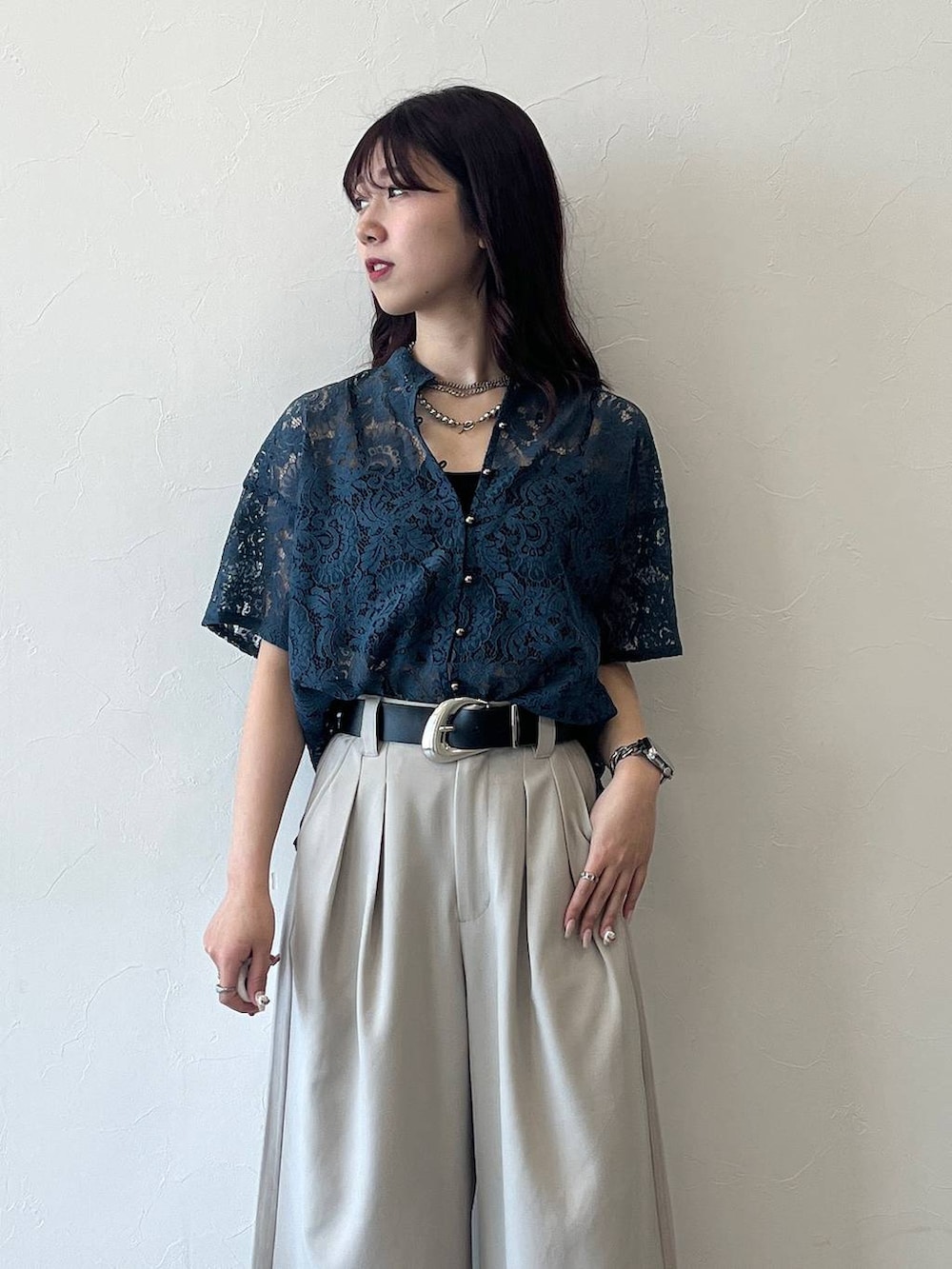 グリーン系のシャツ/ブラウス、ベージュ系のスラックス、ブラック系のベルトを着用したレディースの春コーディネートの4枚目の写真