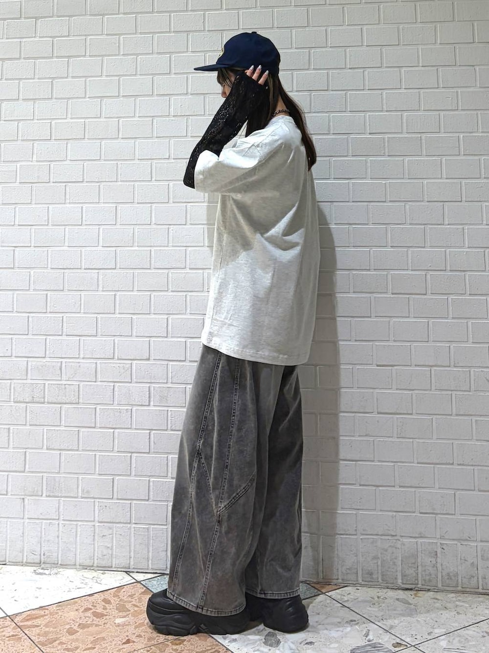 ブラック系のTシャツ/カットソー、グレー系のTシャツ/カットソー、ブラック系のデニムパンツを着用したレディースの春コーディネートの6枚目の写真