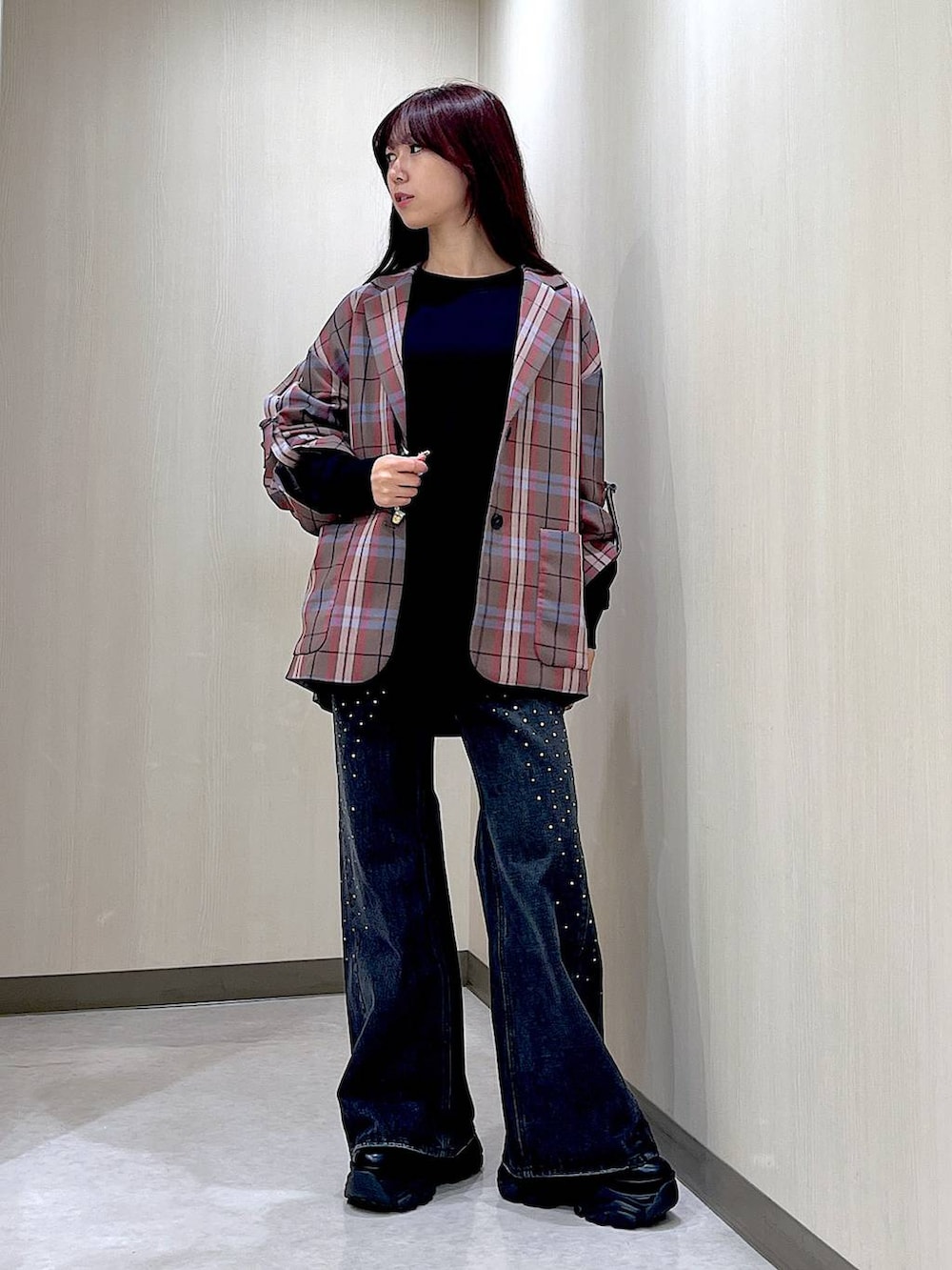 ブラック系のデニムパンツ、ブラック系のブーツ、ブラウン系のテーラードジャケットを着用したレディースの秋コーディネートの2枚目の写真