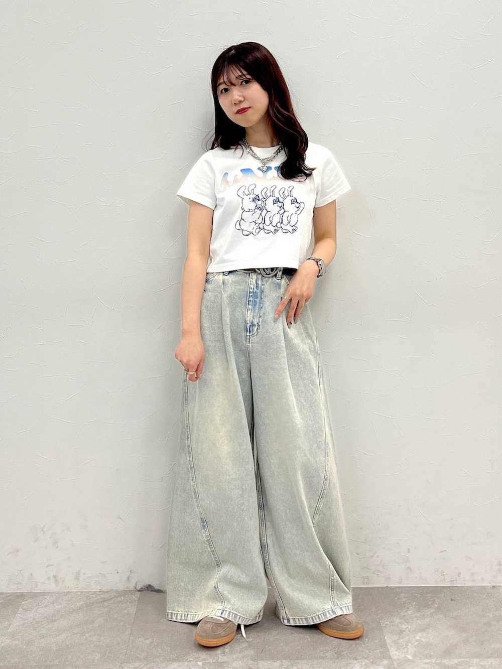 ブルー系のデニムパンツ、ホワイト系のTシャツ/カットソー、ブラウン系のベルトを着用したレディースの春コーディネートの5枚目の写真