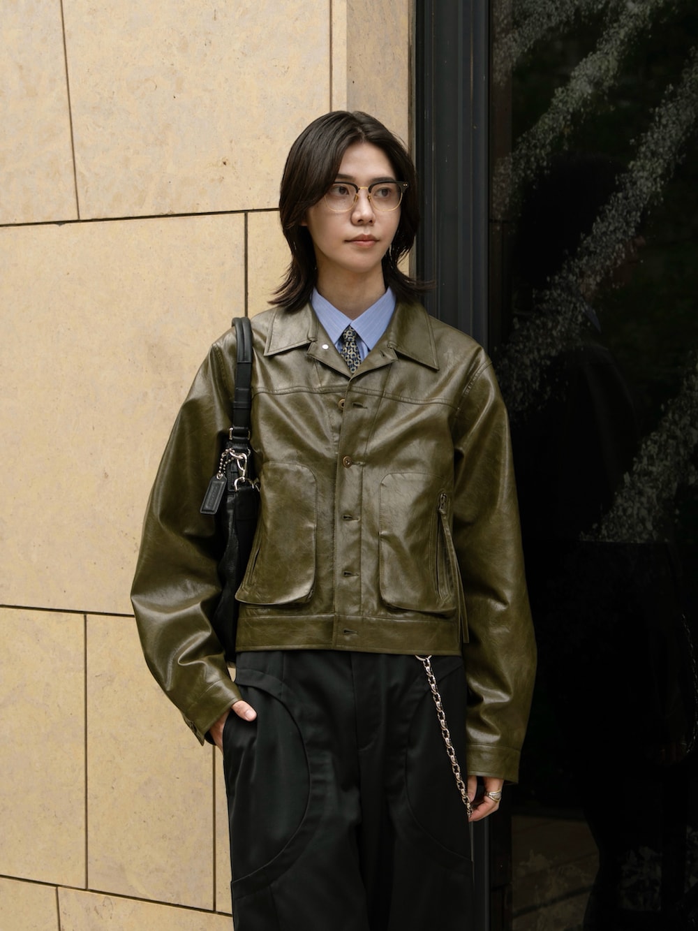 グリーン系のその他アウター、ブラック系のスラックスを着用したメンズの秋コーディネートの2枚目の写真