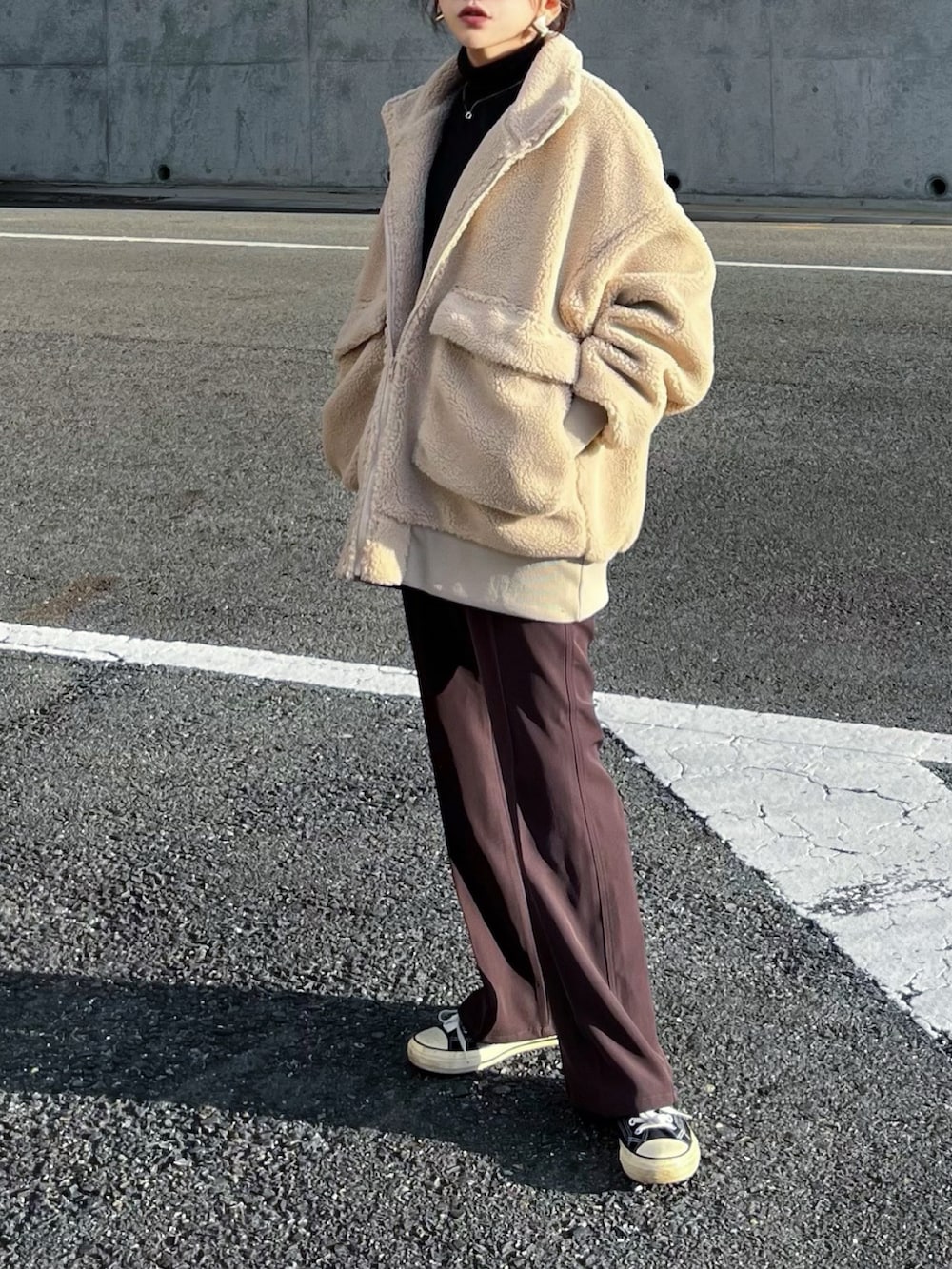 ベージュ系のブルゾン、ブラウン系のその他パンツ、ブラック系のTシャツ/カットソーを着用したレディースの冬コーディネートの3枚目の写真