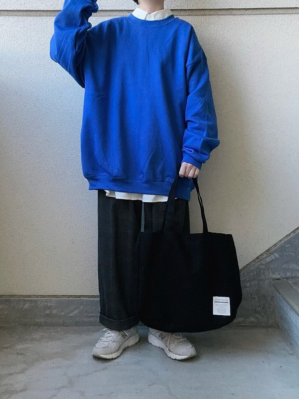 ブラック系のトートバッグ、ホワイト系のシャツ/ブラウス、グレー系のスラックスを着用したレディースの秋コーディネートの4枚目の写真