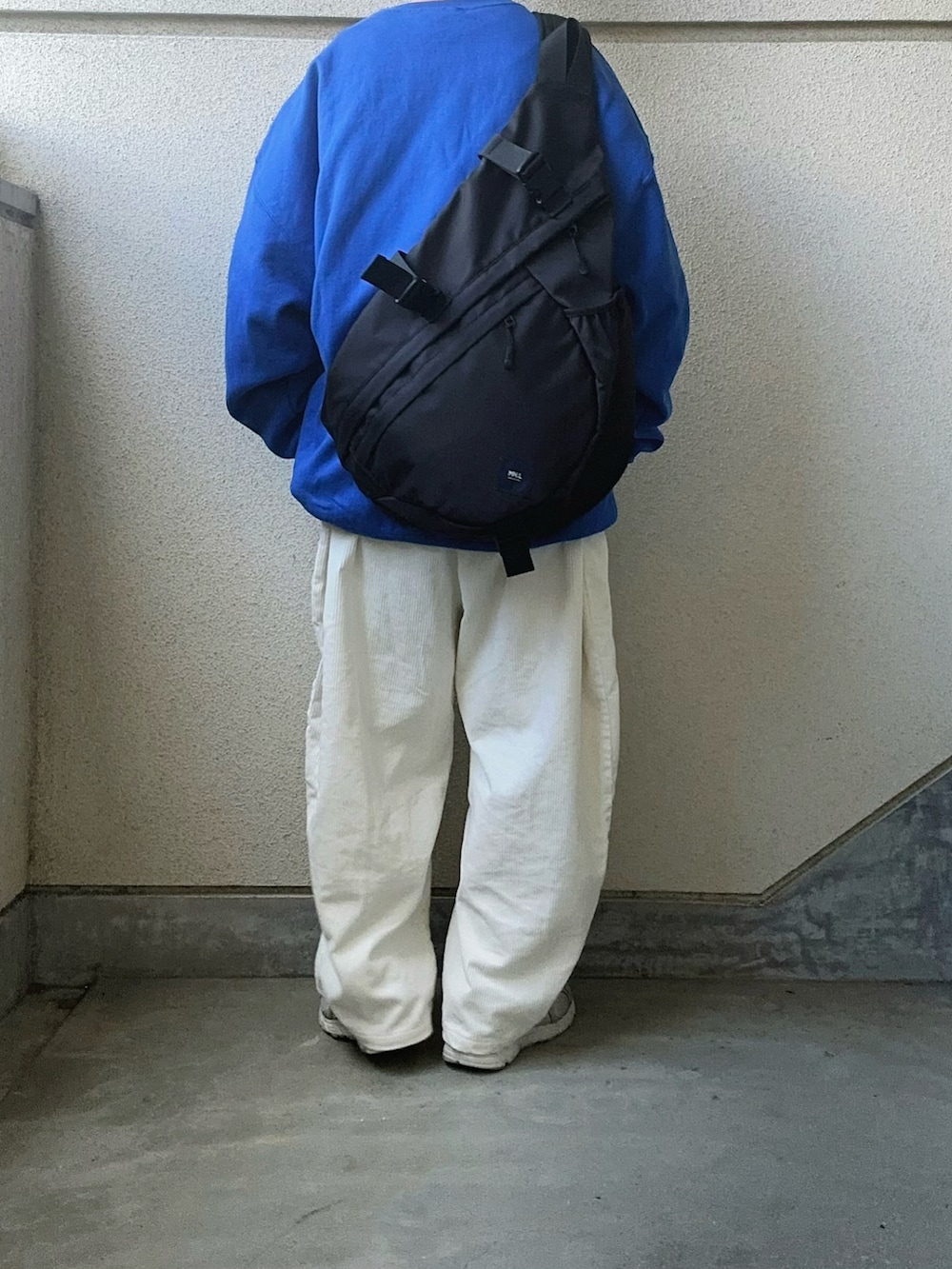 ブラック系のボディバッグ/ウエストポーチを着用したレディースの冬コーディネートの2枚目の写真