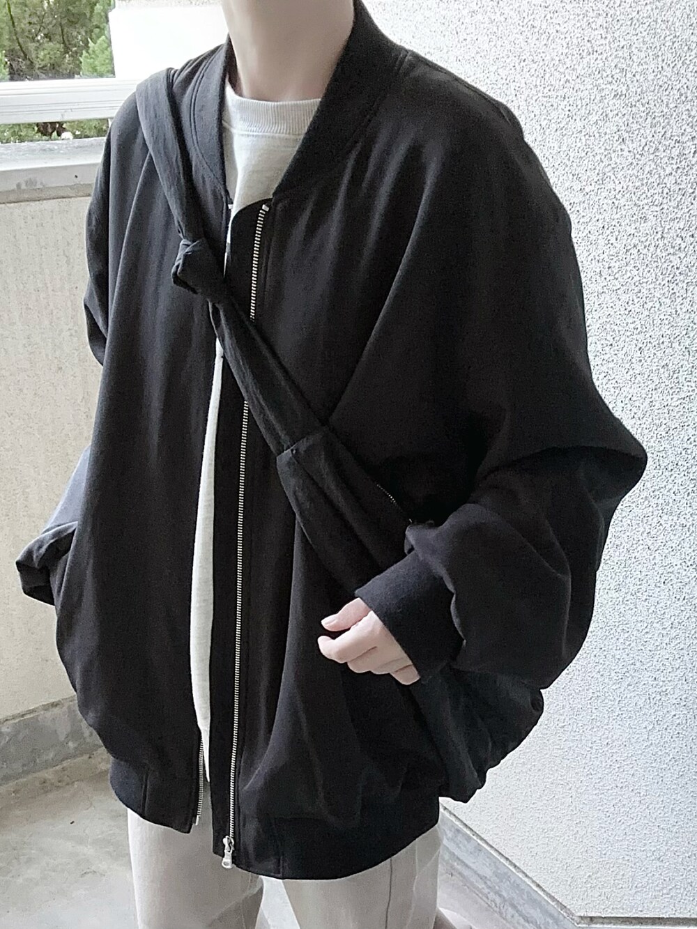 ブラック系のMA-1、ベージュ系のデニムパンツを着用したレディースの秋コーディネートの4枚目の写真