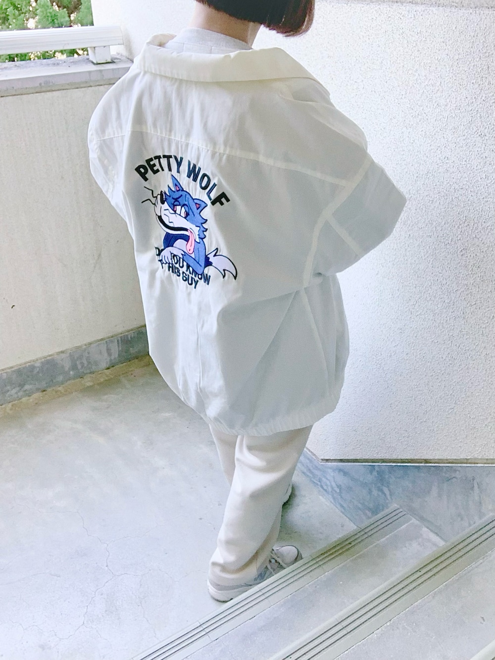 ホワイト系のブルゾン、ホワイト系のスウェットパンツ、グレー系のスニーカーを着用したレディースの冬コーディネートの4枚目の写真