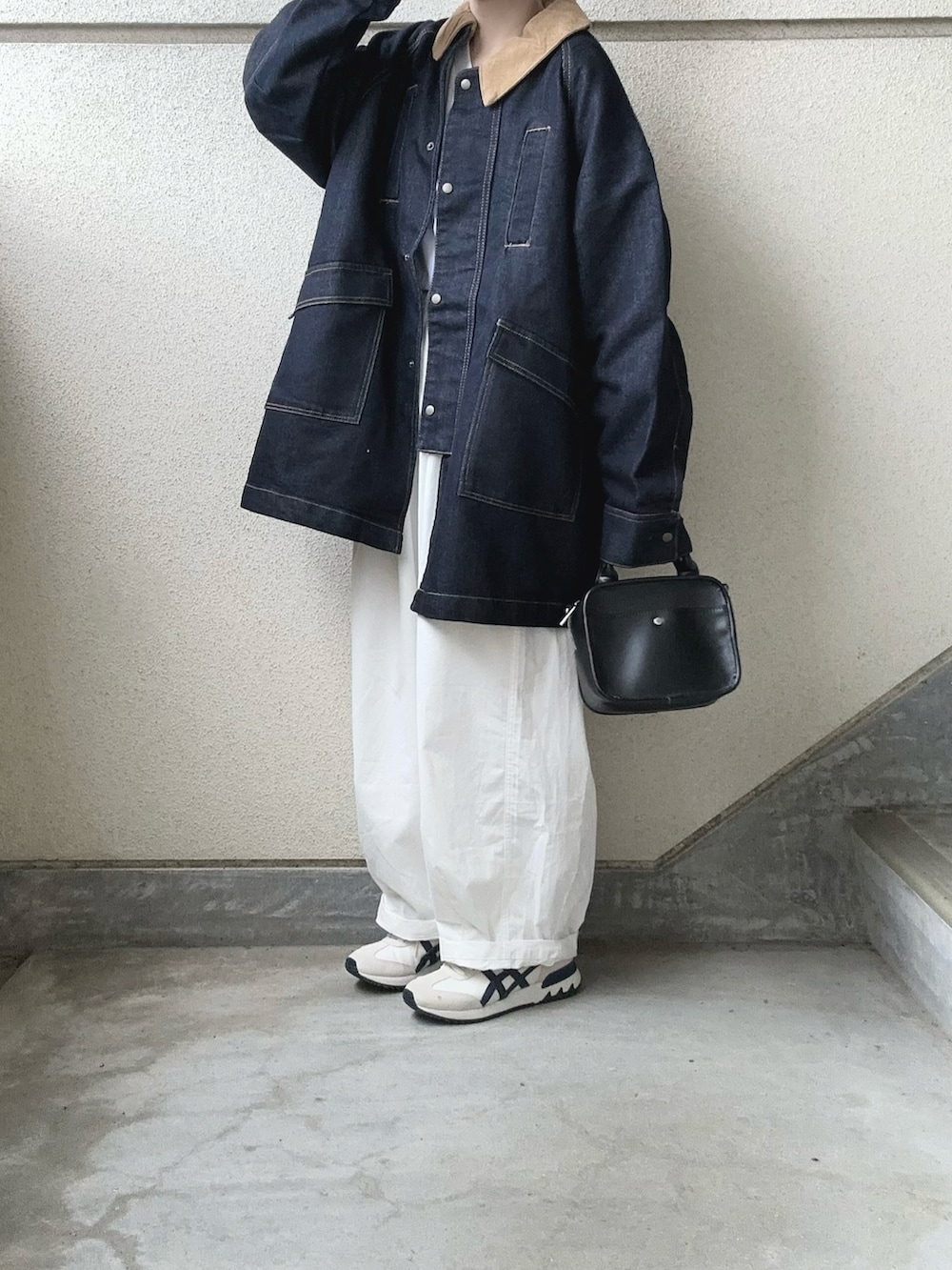 ブルー系のデニムジャケット、ホワイト系のチノパンツ、ベージュ系のスニーカーを着用したレディースの秋コーディネートの5枚目の写真