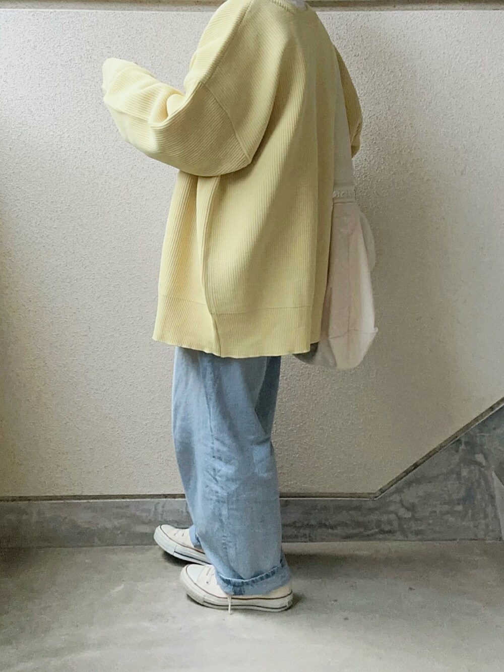 イエロー系のカーディガン/ボレロ、ホワイト系のショルダーバッグを着用したレディースの冬コーディネートの5枚目の写真