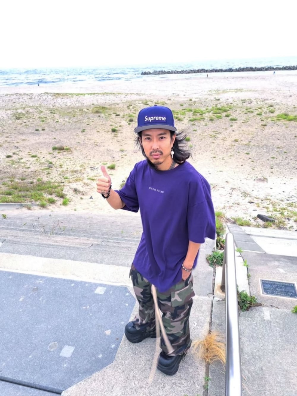 パープル系のTシャツ/カットソー、その他のカーゴパンツ、ブラック系のシューズを着用したメンズの夏コーディネートの4枚目の写真