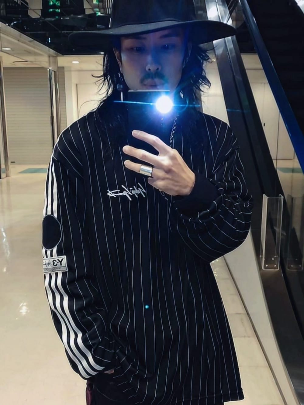 ピンク系のデニムパンツ、ブラック系のジャージ、ブラック系のハットを着用したメンズの春コーディネートの4枚目の写真