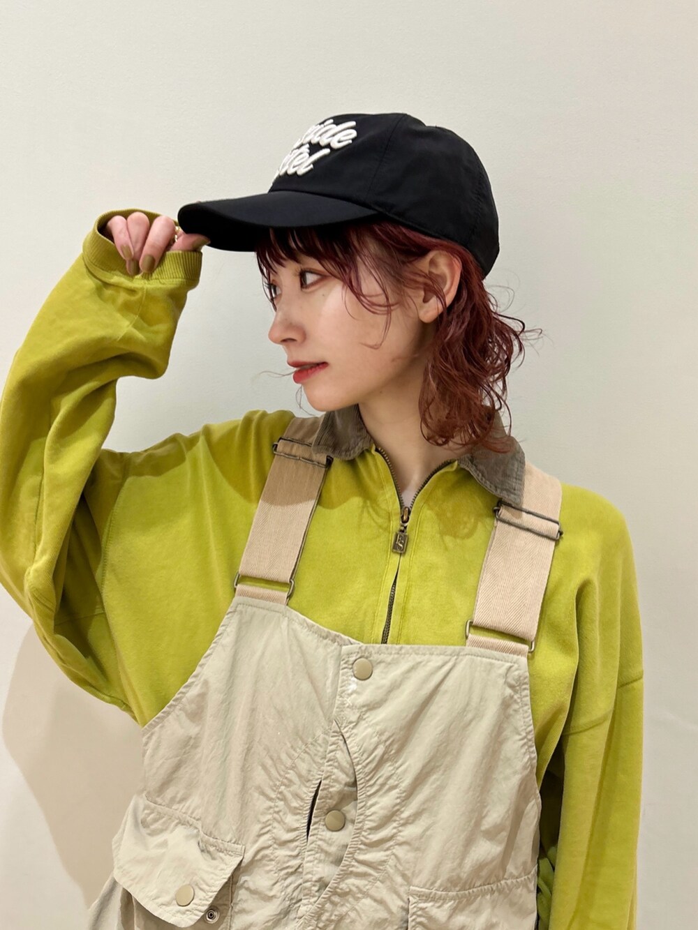 グリーン系のトップス、ベージュ系のベスト、ブラック系のデニムパンツを着用したレディースの冬コーディネートの2枚目の写真