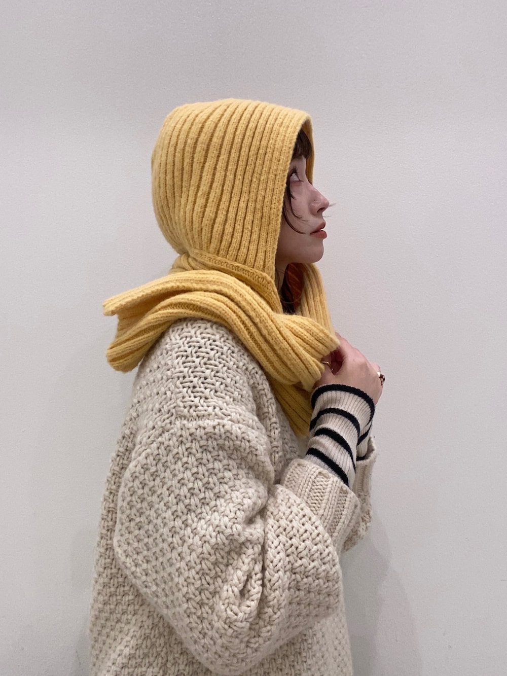 ホワイト系のニット/セーター、ホワイト系のニット/セーター、パープル系のパンツを着用したレディースの冬コーディネートの4枚目の写真