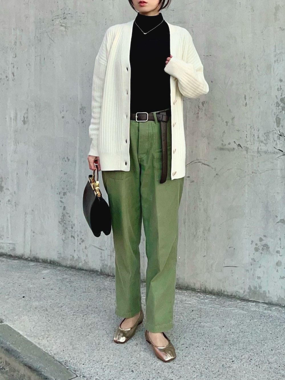 ブラック系のTシャツ/カットソー、ホワイト系のカーディガン/ボレロ、グリーン系のその他パンツを着用したレディースの冬コーディネートの2枚目の写真