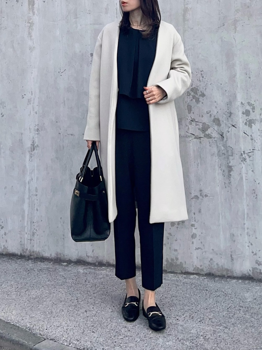 ブルー系のパンツドレス、ブラック系のローファー、ブラック系のトートバッグを着用したレディースの冬コーディネートの5枚目の写真