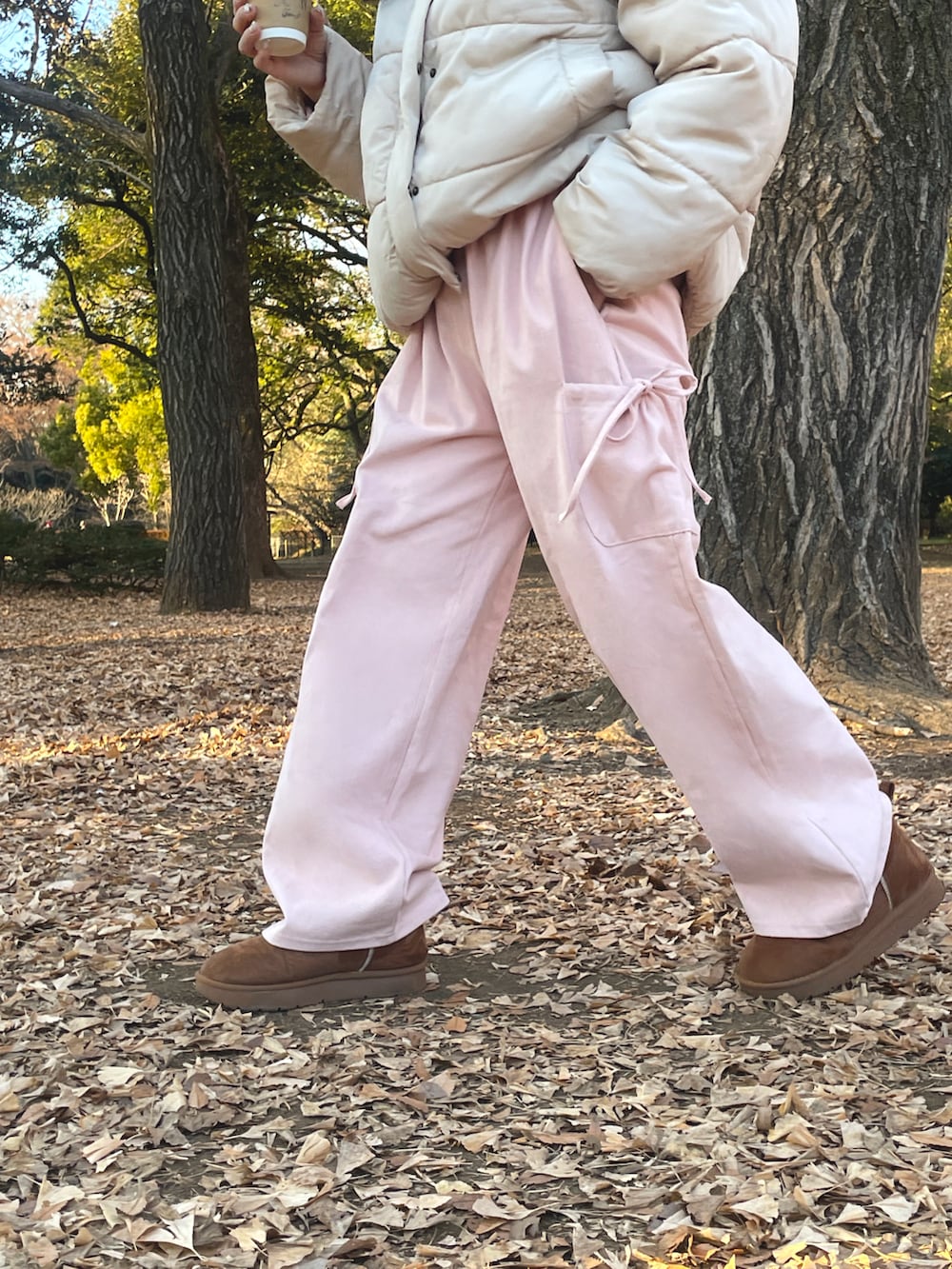 ベージュ系のブーツ、ピンク系のパンツ、ベージュ系のダウンジャケット/コートを着用したレディースの冬コーディネートの2枚目の写真