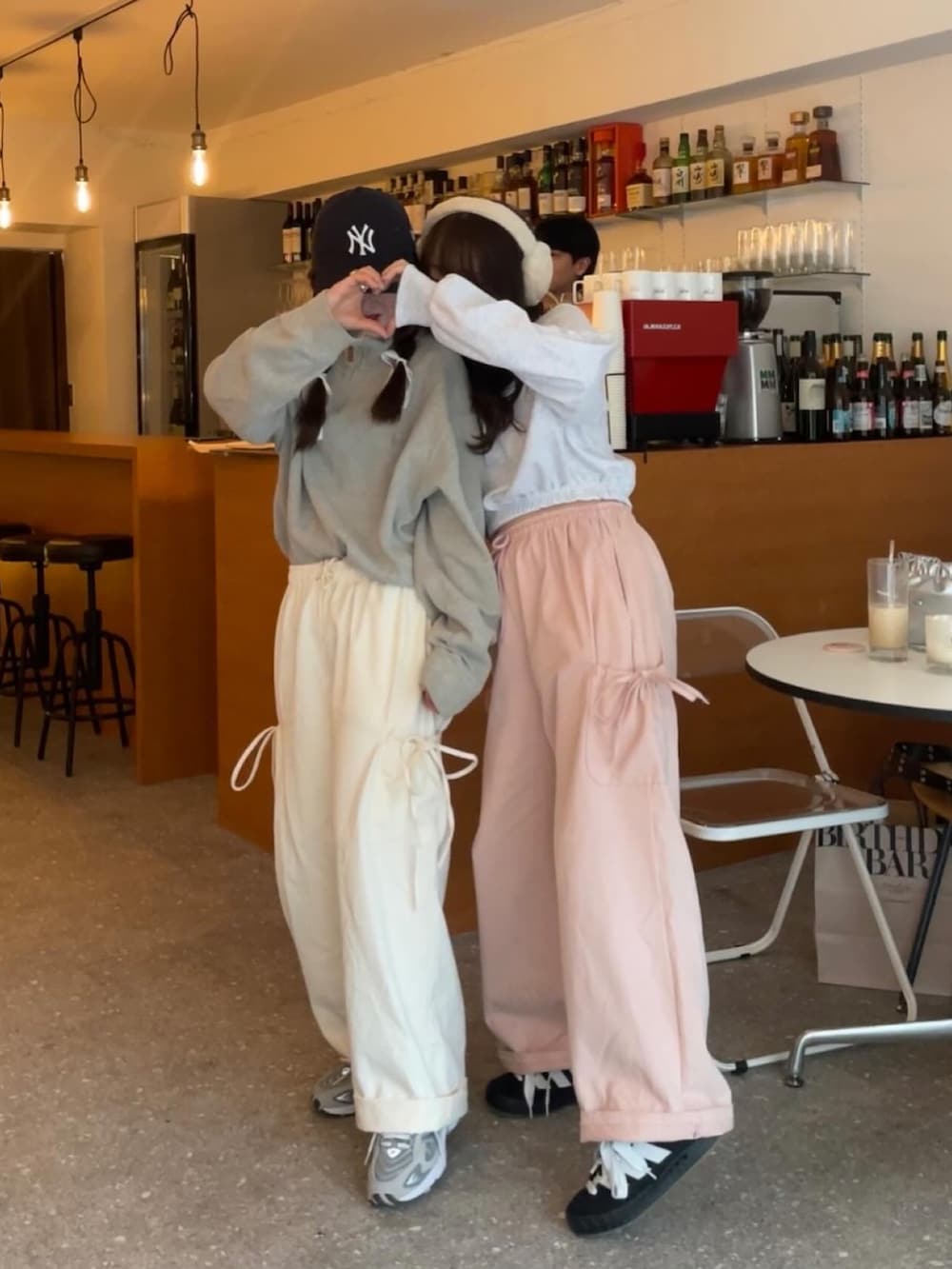 グレー系のトップス、グレー系のスウェット、ピンク系のカーゴパンツを着用したレディースの冬コーディネートの3枚目の写真