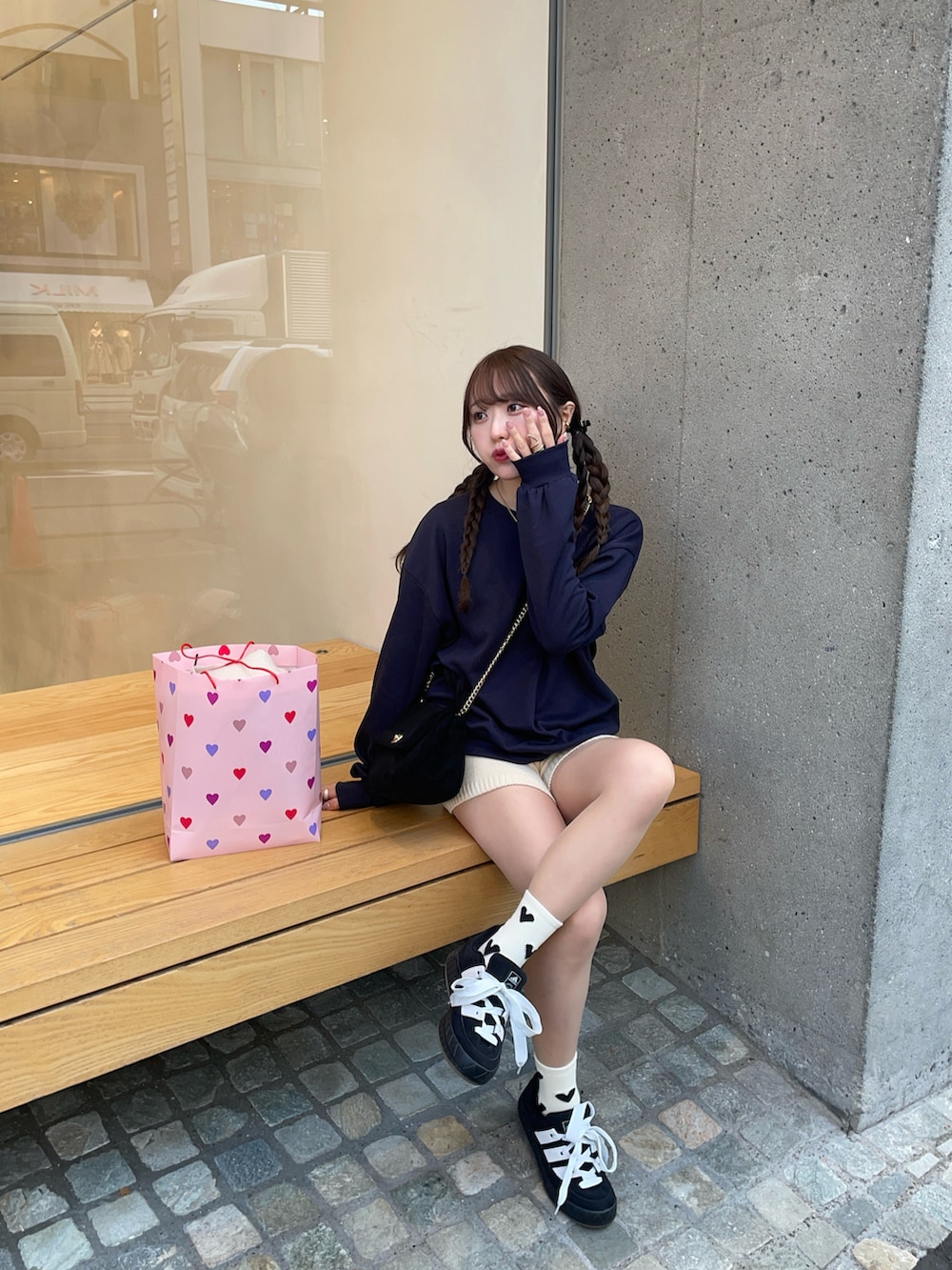 ブラック系のスニーカー、ブルー系のスウェット、ブラック系のショルダーバッグを着用したレディースの冬コーディネートの2枚目の写真