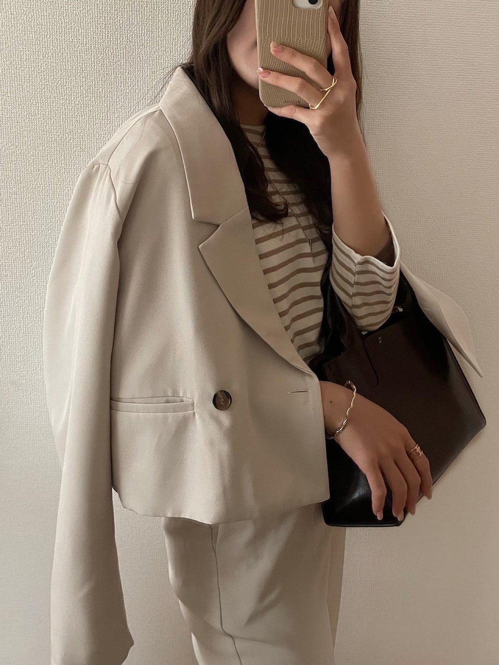 ベージュ系のテーラードジャケットを着用したレディースの春コーディネートの2枚目の写真
