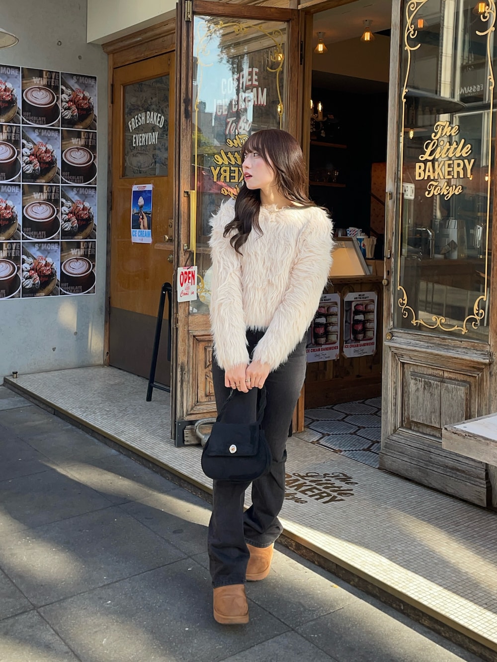 ベージュ系のブーツ、ブラック系のデニムパンツ、ベージュ系のニット/セーターを着用したレディースの冬コーディネートの3枚目の写真