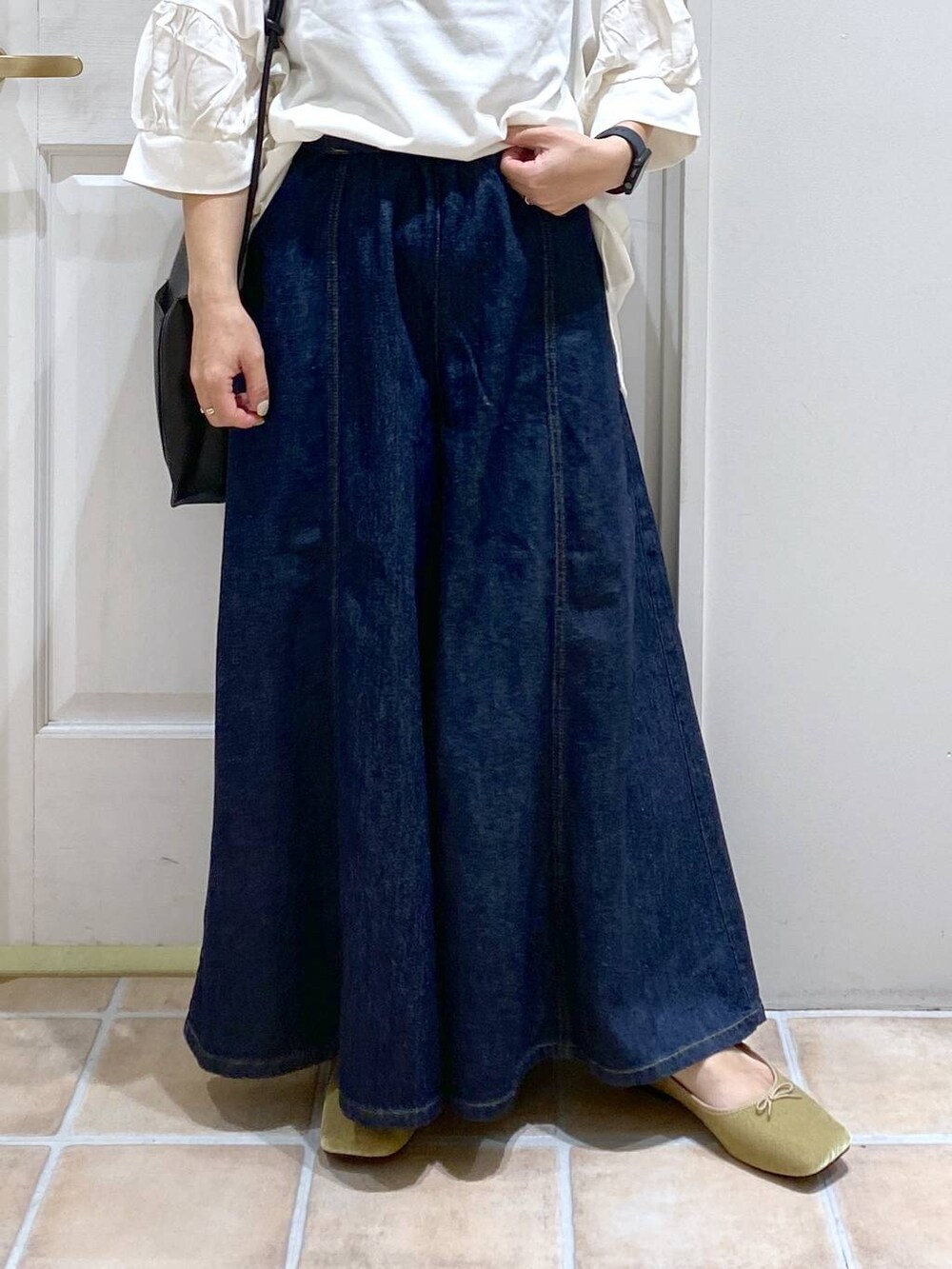 ホワイト系のTシャツ/カットソー、ブルー系のデニムパンツ、グリーン系のパンプスを着用したレディースの夏コーディネートの3枚目の写真