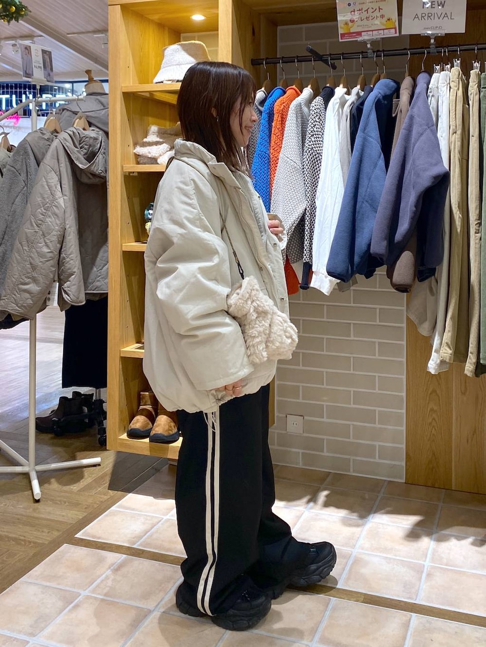 ベージュ系のブルゾン、グレー系のニット/セーター、ホワイト系のTシャツ/カットソーを着用したレディースの冬コーディネートの4枚目の写真