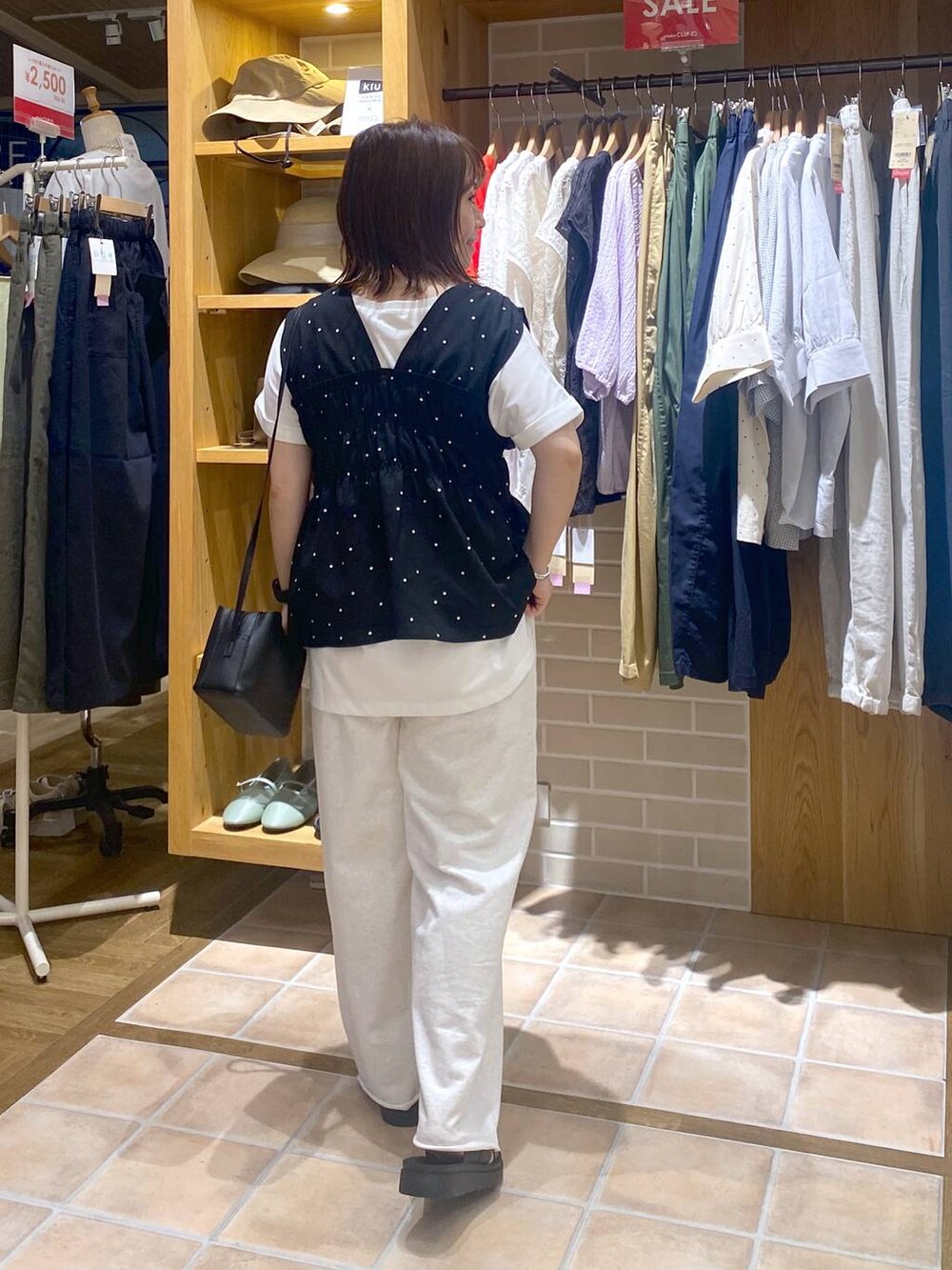 ブラック系のサンダル、ブラック系のその他パンツ、ホワイト系のTシャツ/カットソーを着用したレディースの夏コーディネートの5枚目の写真