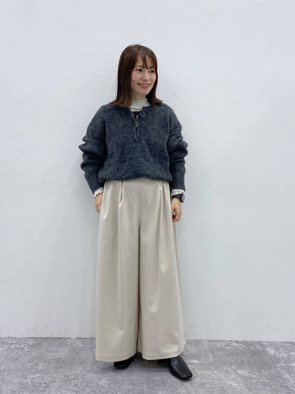 グレー系のTシャツ/カットソー、ブラック系のブーツ、ベージュ系のその他パンツを着用したレディースの冬コーディネートの4枚目の写真