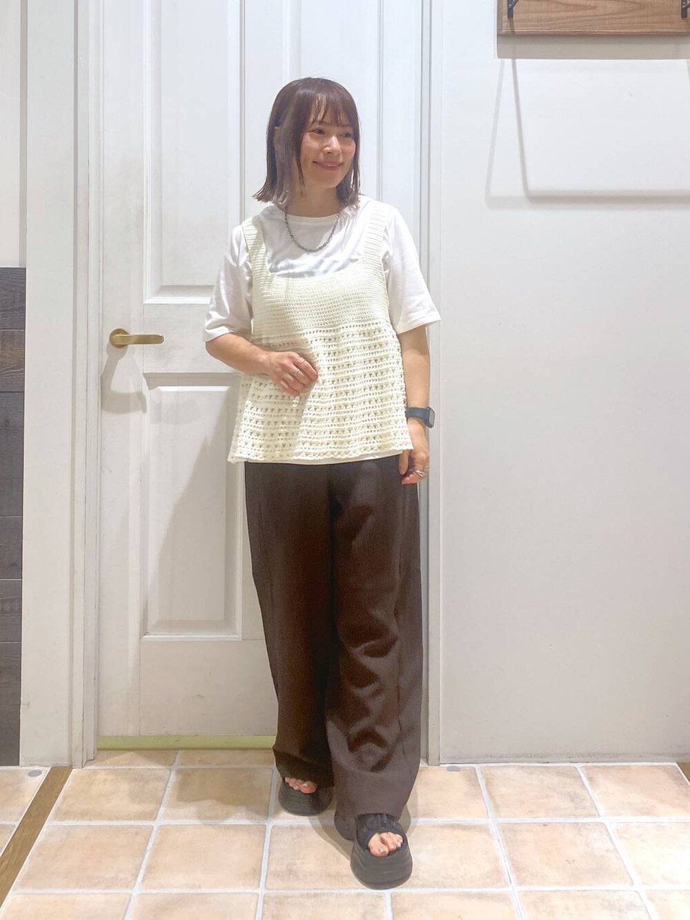 ブラック系のサンダル、ブラウン系のその他パンツ、ホワイト系のTシャツ/カットソーを着用したレディースの秋コーディネートの3枚目の写真